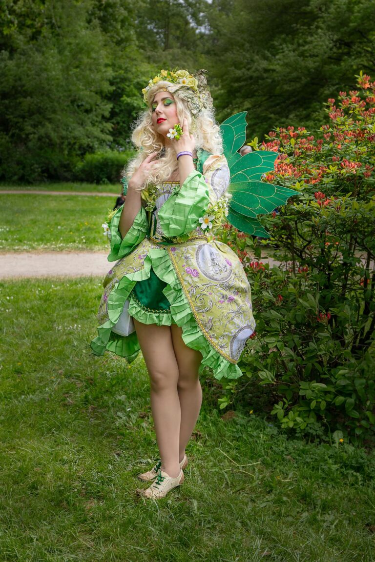 A woman dressed in green and white costume